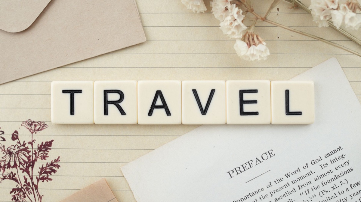 Travel coupon FAQ, phone screen, notebook, pen